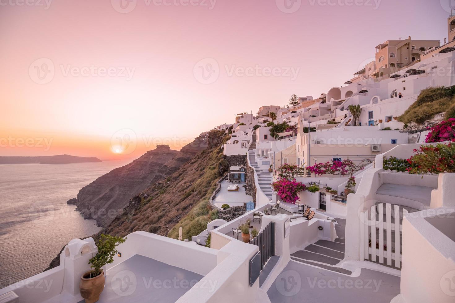 Summer vacation panorama, luxury famous Europe destination. White architecture in Santorini, Greece. Perfect travel scenery with pink flowers and cruise ship in sunlight and blue sky. Amazing view photo
