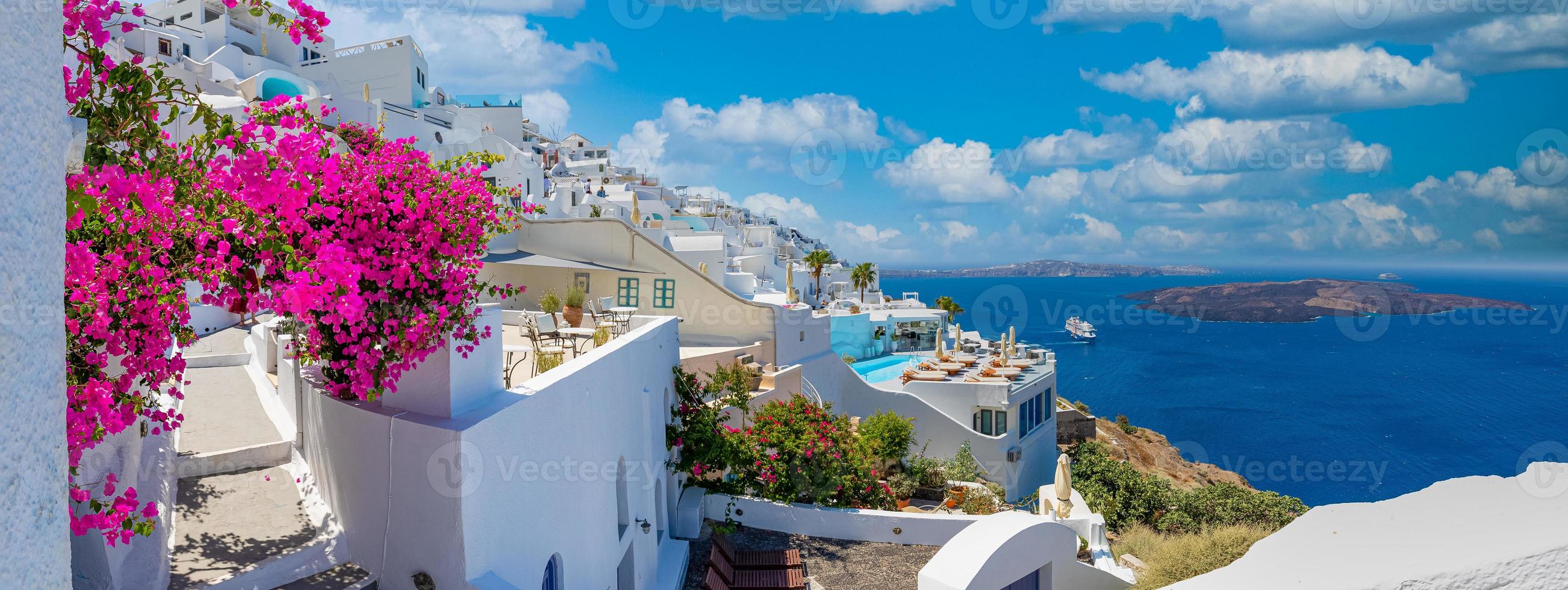Summer vacation panorama, luxury famous Europe destination. White architecture in Santorini, Greece. Perfect travel scenery with pink flowers and cruise ship in sunlight and blue sky. Amazing view photo