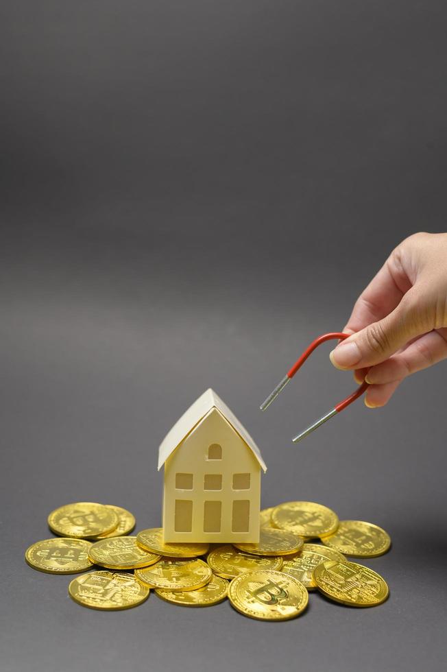 Small white model home with Cryptocurrency bitcoin ,bitcoin mining and financial concept photo
