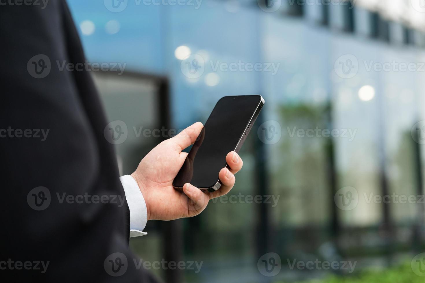 Image of a man holding a mobile phone in his hand photo