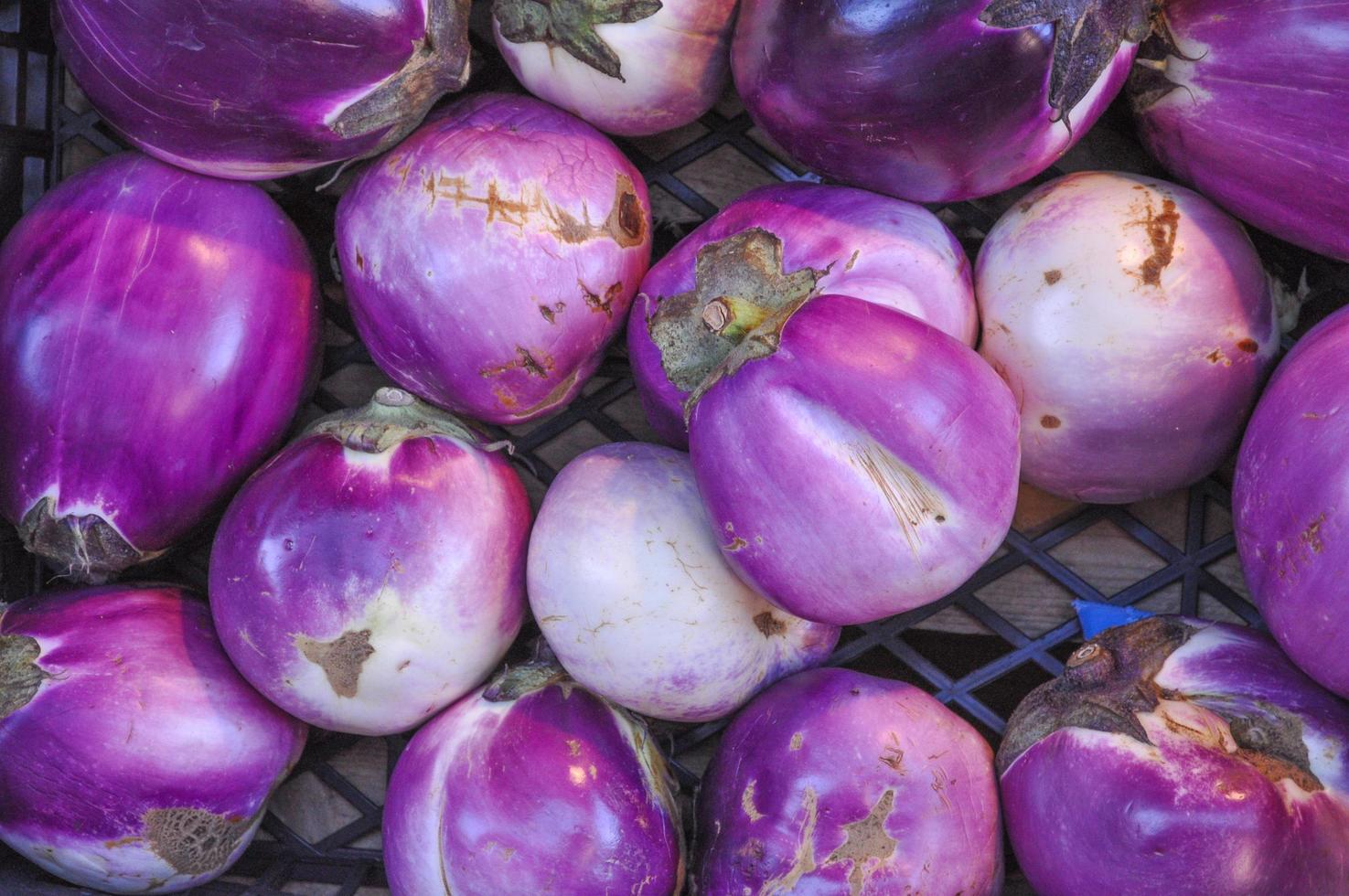 Aubergines vegetables in crate on a market shelf photo