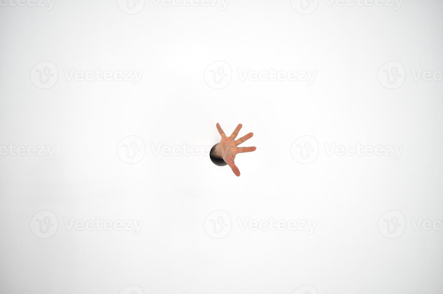 Hand in a hole through a wall photo