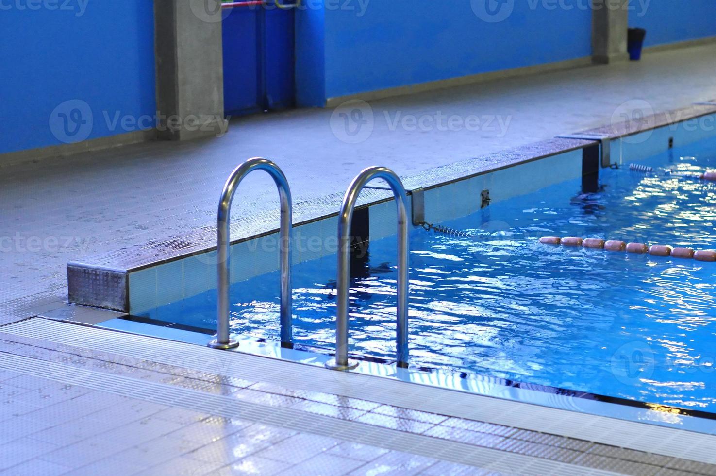 Swimming pool with blue water useful as background photo