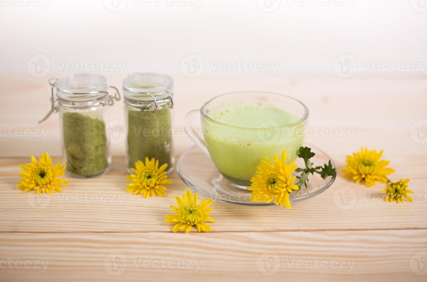 Matcha latte in a cup with matcha powder photo