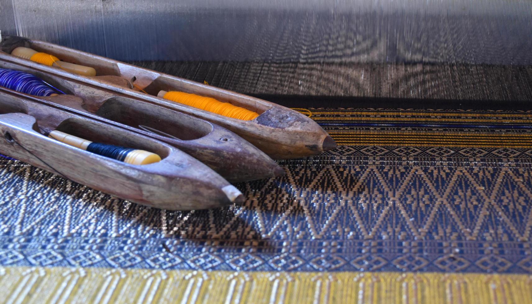 Weaving bobbins used with small looms made from wood for weaving in rural Thai households. photo