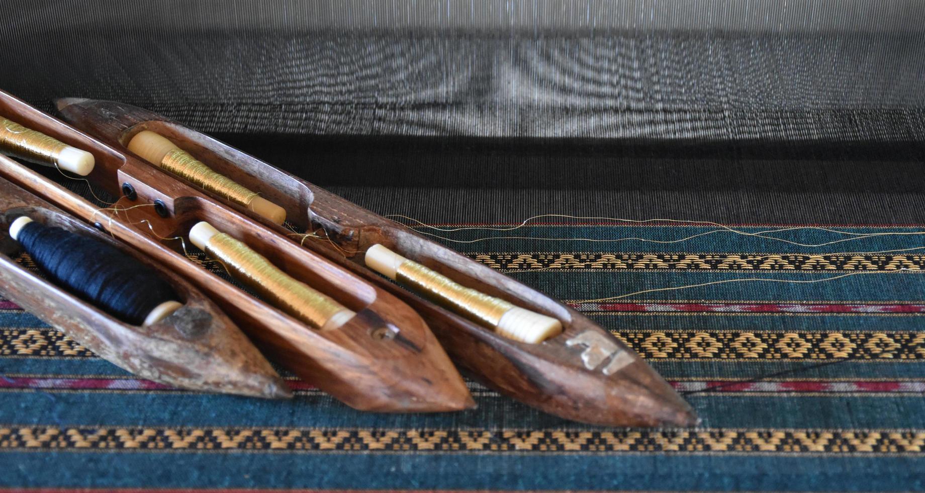 Weaving bobbins used with small looms made from wood for weaving in rural Thai households. photo