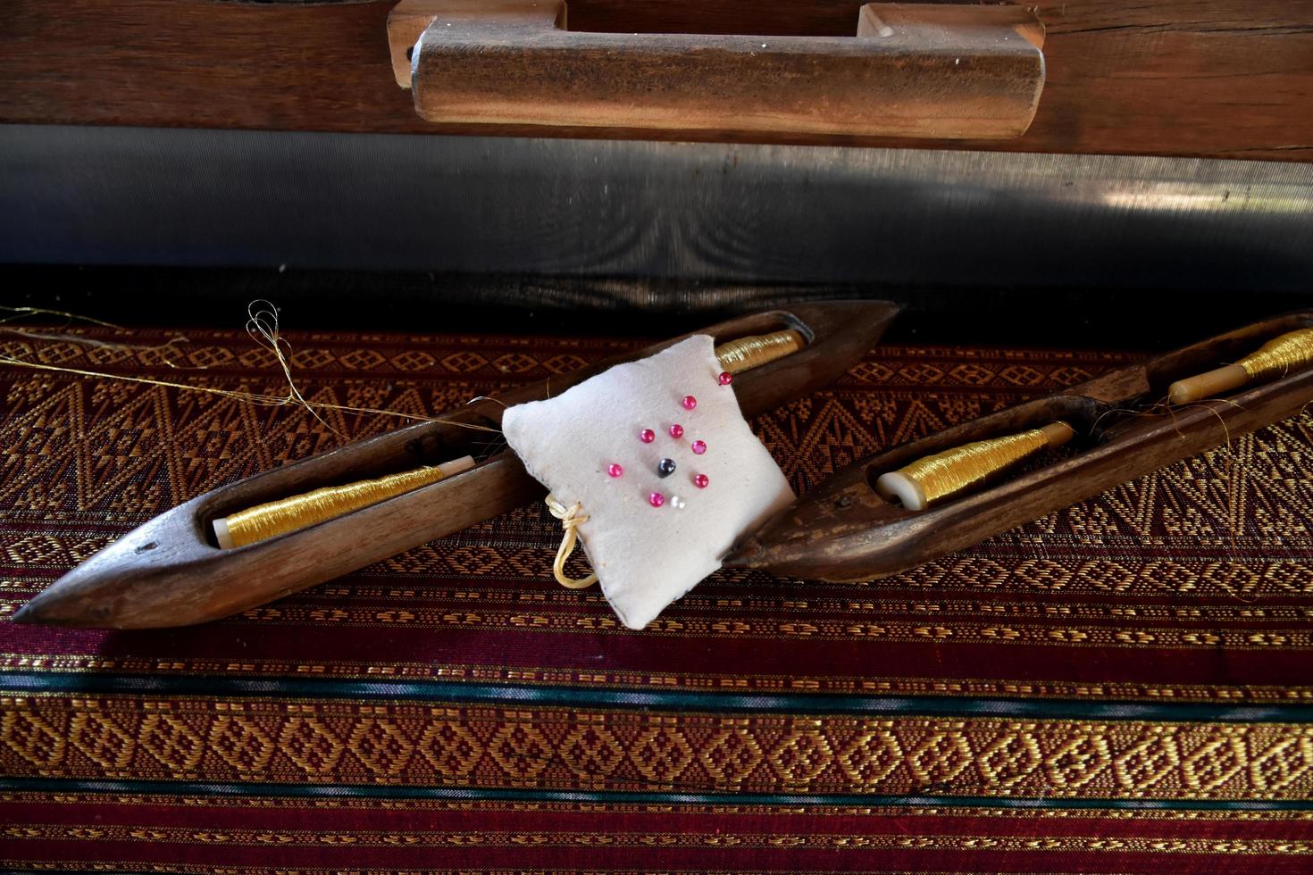 Weaving bobbins used with small looms made from wood for weaving in rural Thai households. photo