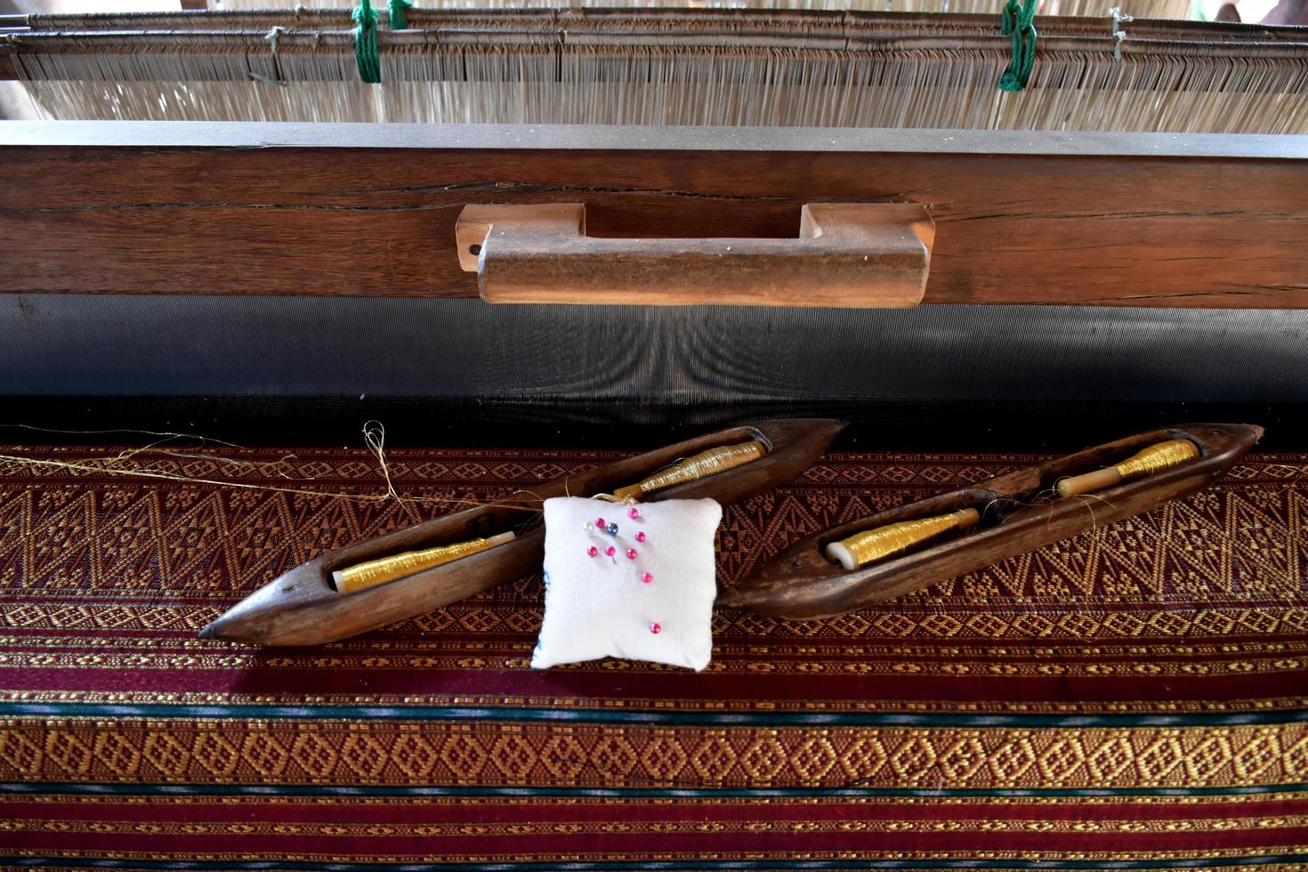 Weaving bobbins used with small looms made from wood for weaving in rural Thai households. photo