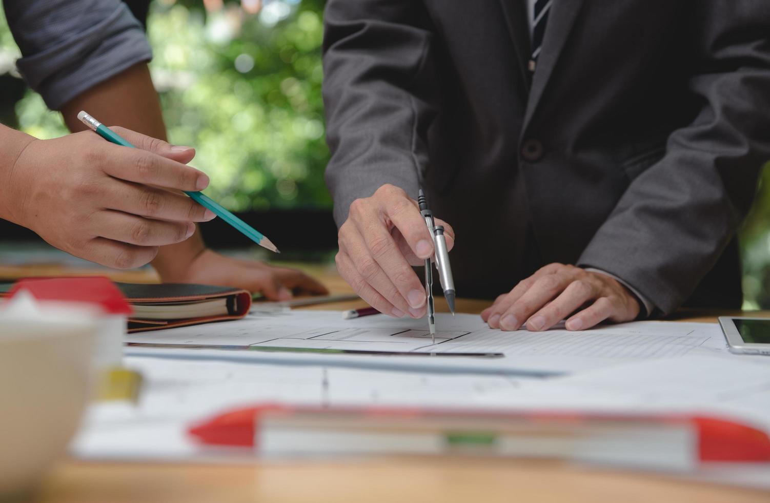 Team of architects or engineer discussing on desk with blueprint about new startup project on desk. Team group on construciton site check documents and business workflow.Selective focus. photo