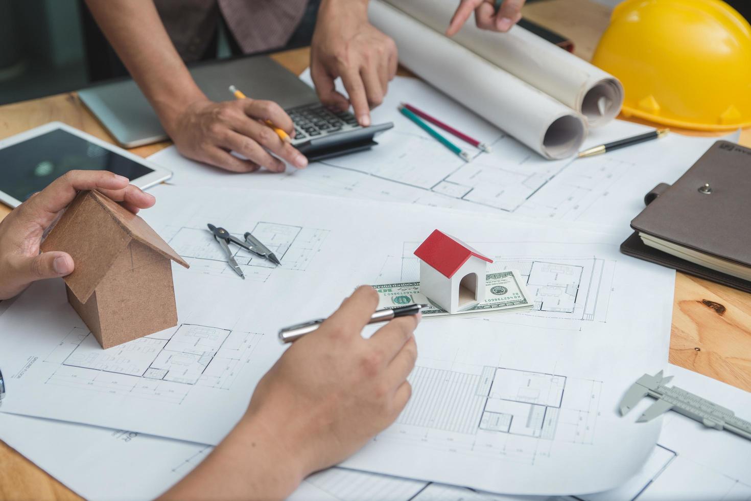 Team of architects or engineer discussing on desk with blueprint about new startup project on desk. Team group on construciton site check documents and business workflow.Selective focus. photo