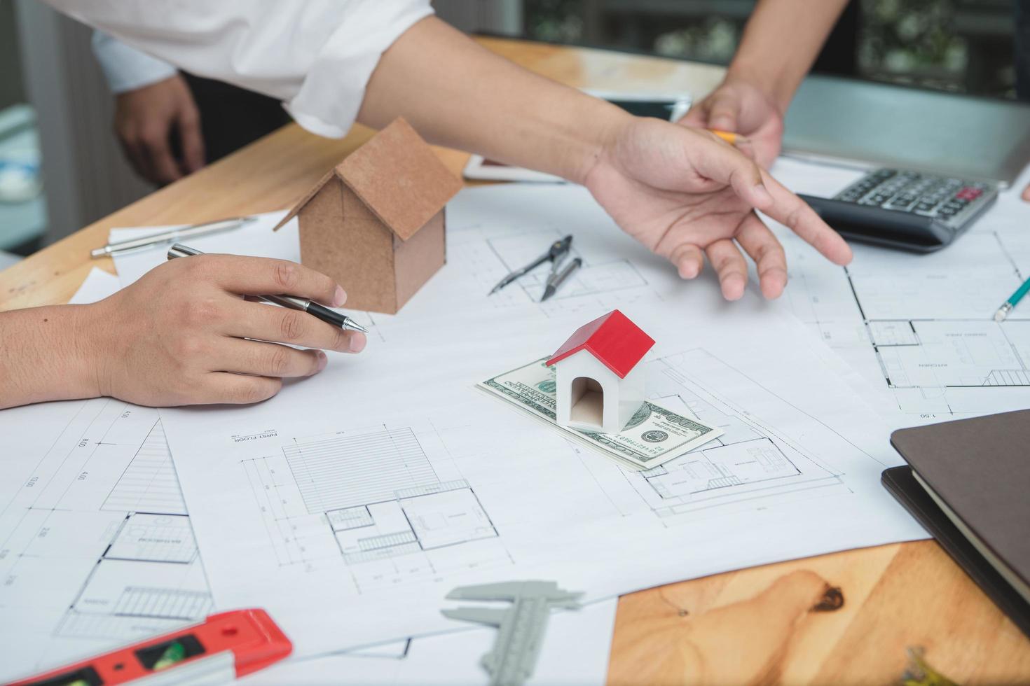 Team of architects or engineer discussing on desk with blueprint about new startup project on desk. Team group on construciton site check documents and business workflow.Selective focus. photo