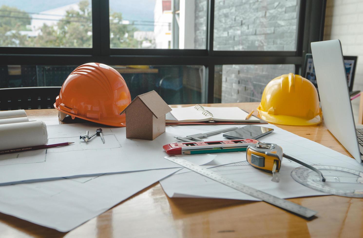 Architectural plans work apace. Architectural project,blueprints,pencil ,labtop and divider compass on wooden desk table.Construction background.Engineering tools. Copy space.Architectural Concept photo