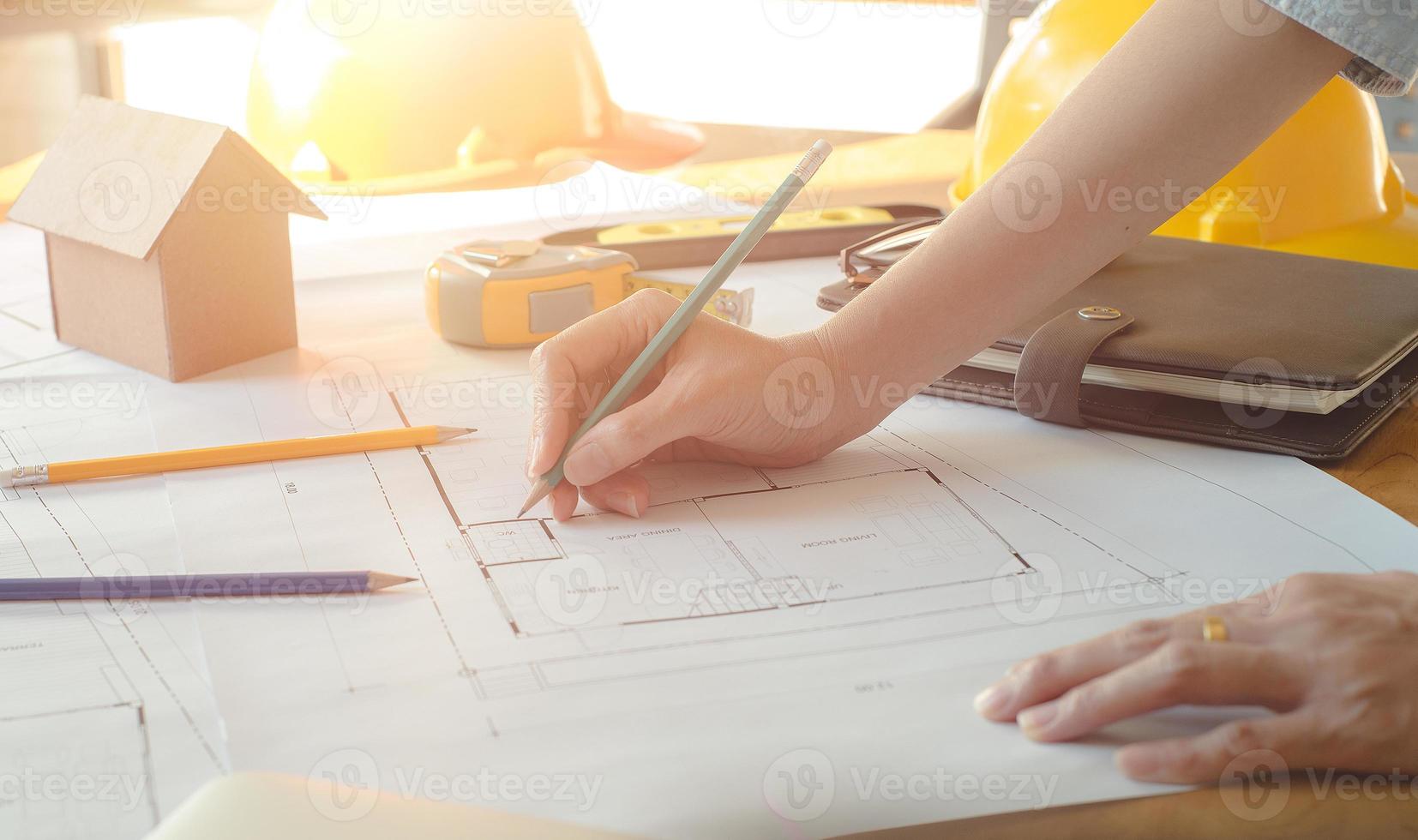 Alone architect woman working with compasses and blueprints for architectural plan,engineer sketching a construction project concept.Architect concept,Vintage Effect photo