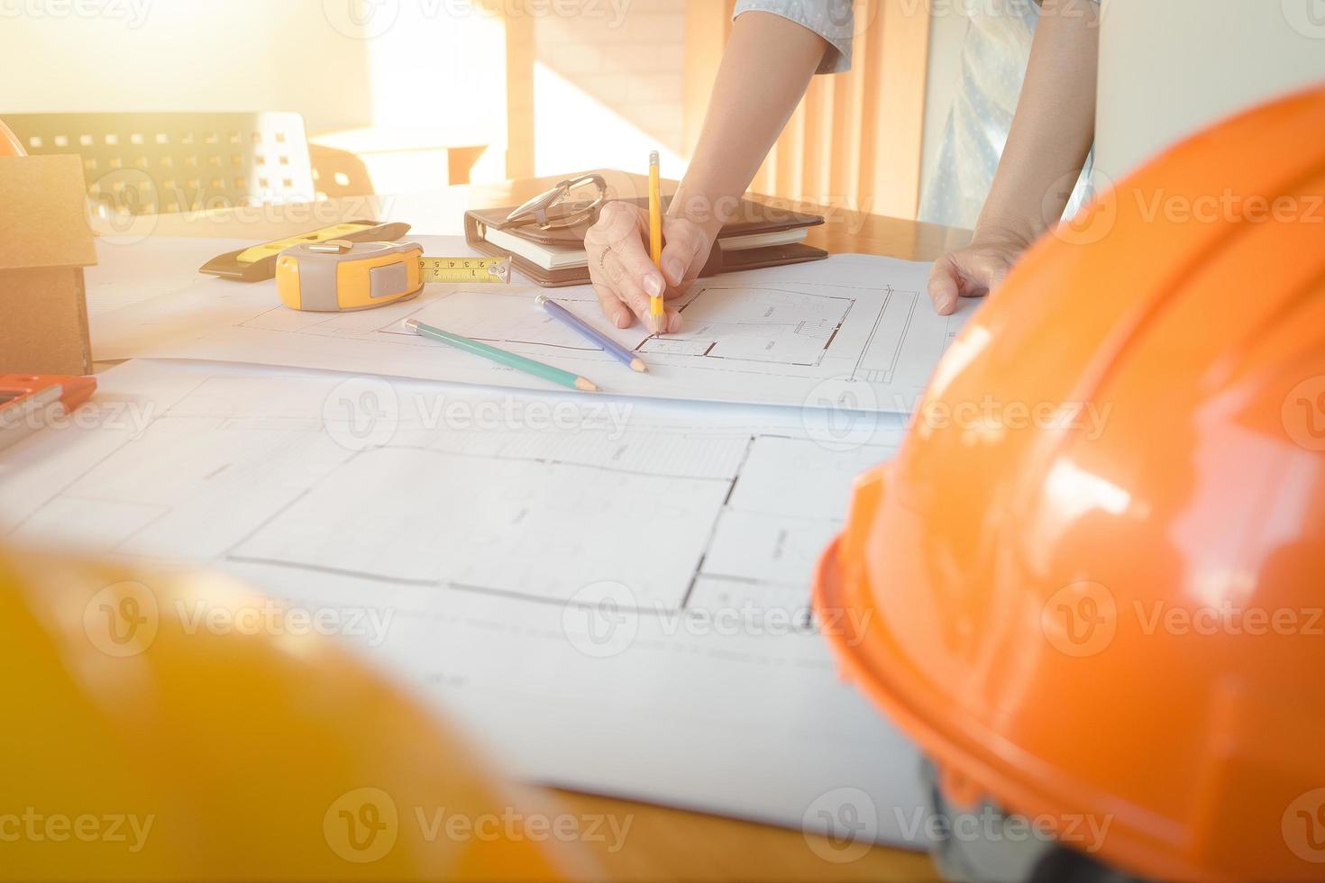 Alone architect woman working with compasses and blueprints for architectural plan,engineer sketching a construction project concept.Architect concept,Vintage Effect photo