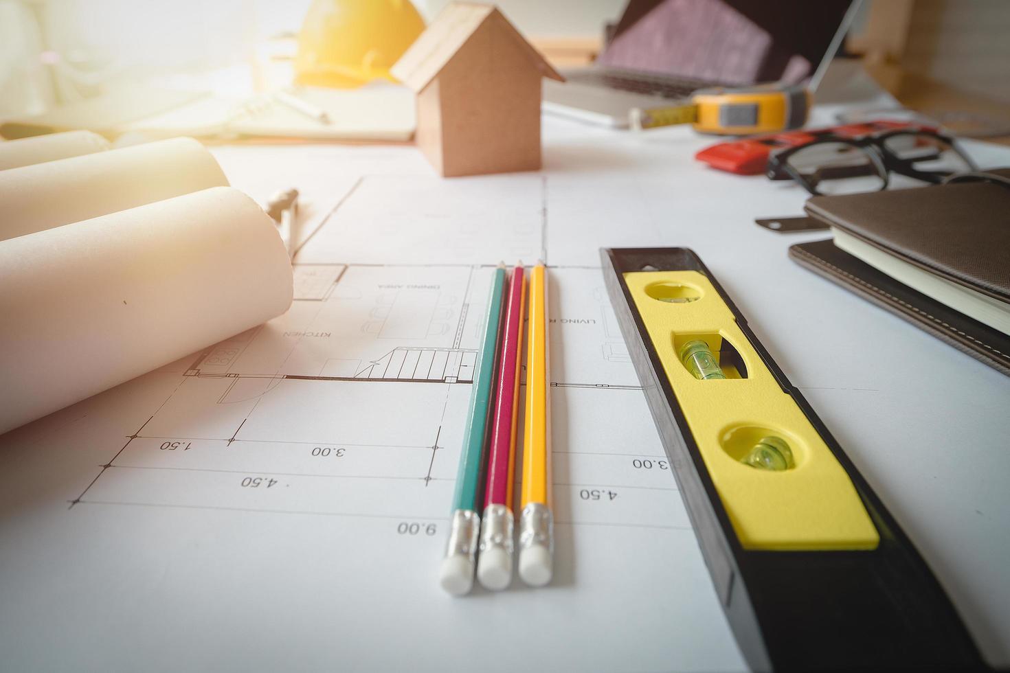 Architectural plans work apace. Architectural project,blueprints,pencil ,labtop and divider compass on wooden desk table.Construction background.Engineering tools. Copy space.Architectural Concept photo