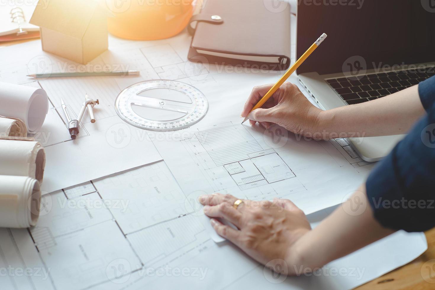 Alone architect woman working with compasses and blueprints for architectural plan,engineer sketching a construction project concept.Architect concept,Vintage Effect photo