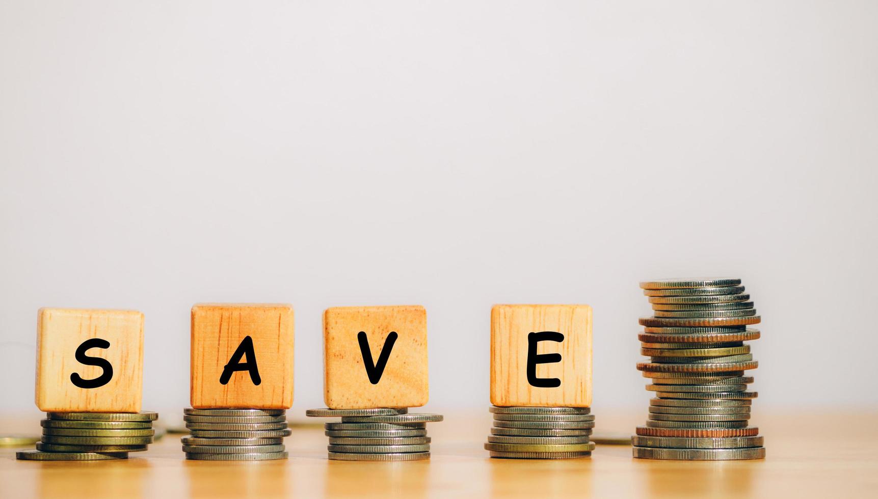 The word SAVE is written from a wooden block or cube to save money invest for future. Concept for loan, property ladder, financial, real estate investment, taxes and bonus. photo