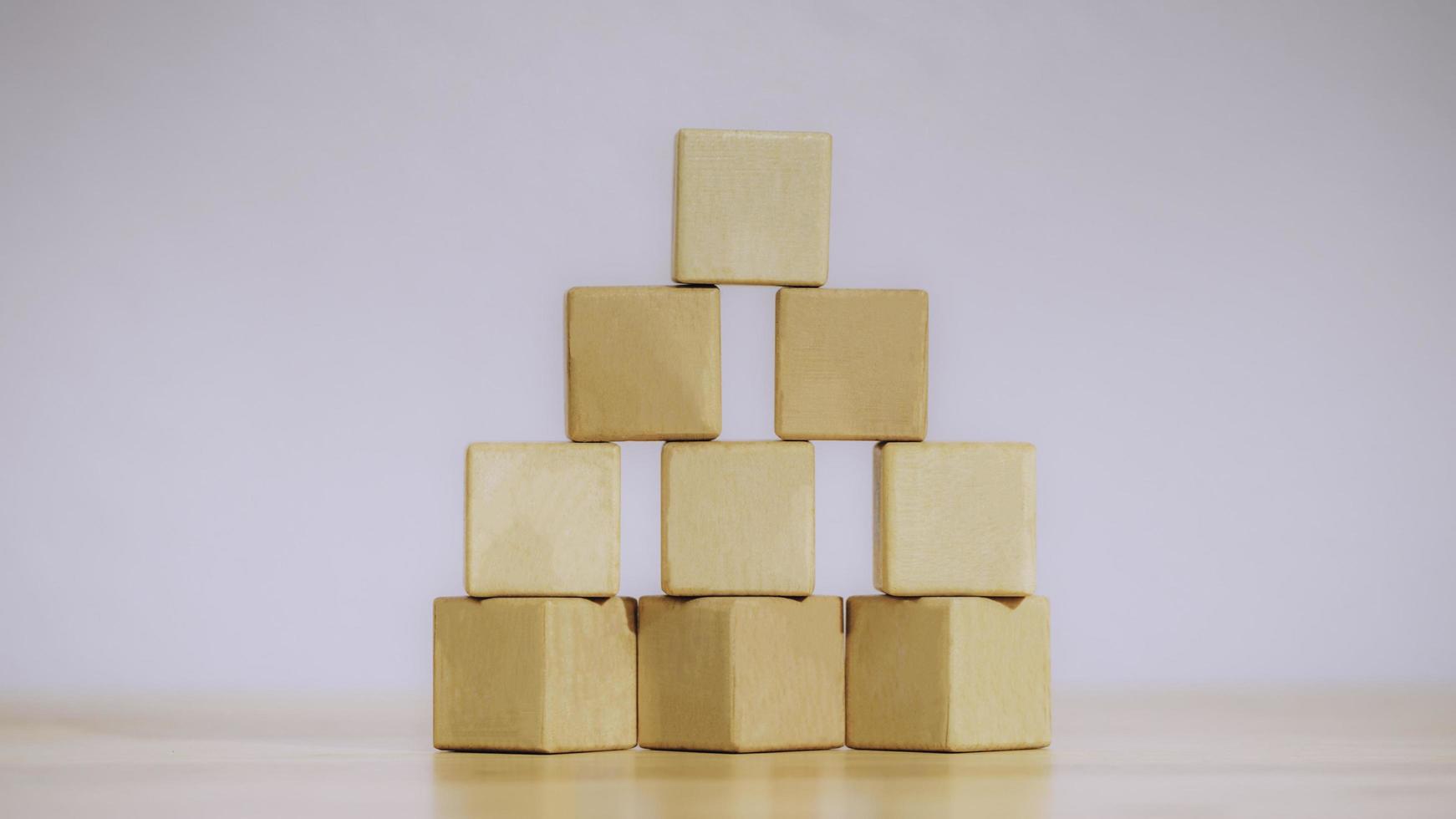 Stacking blank wooden cubes or arrange the wooden blocks on table for input wording and infographic icon. Business concept growth success process, ladder of success, Driving business at peak concept. photo