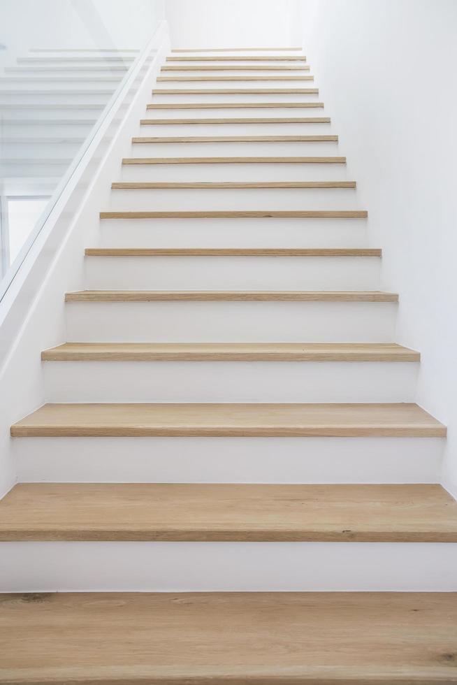 Wooden stairs with clean white walls. photo