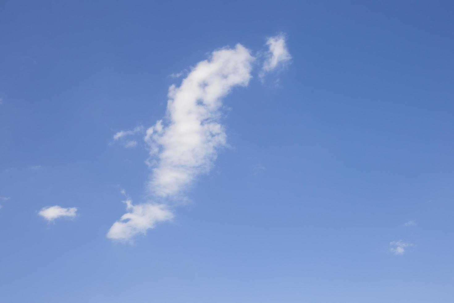 Cloudy sky on a bright blue day background. photo