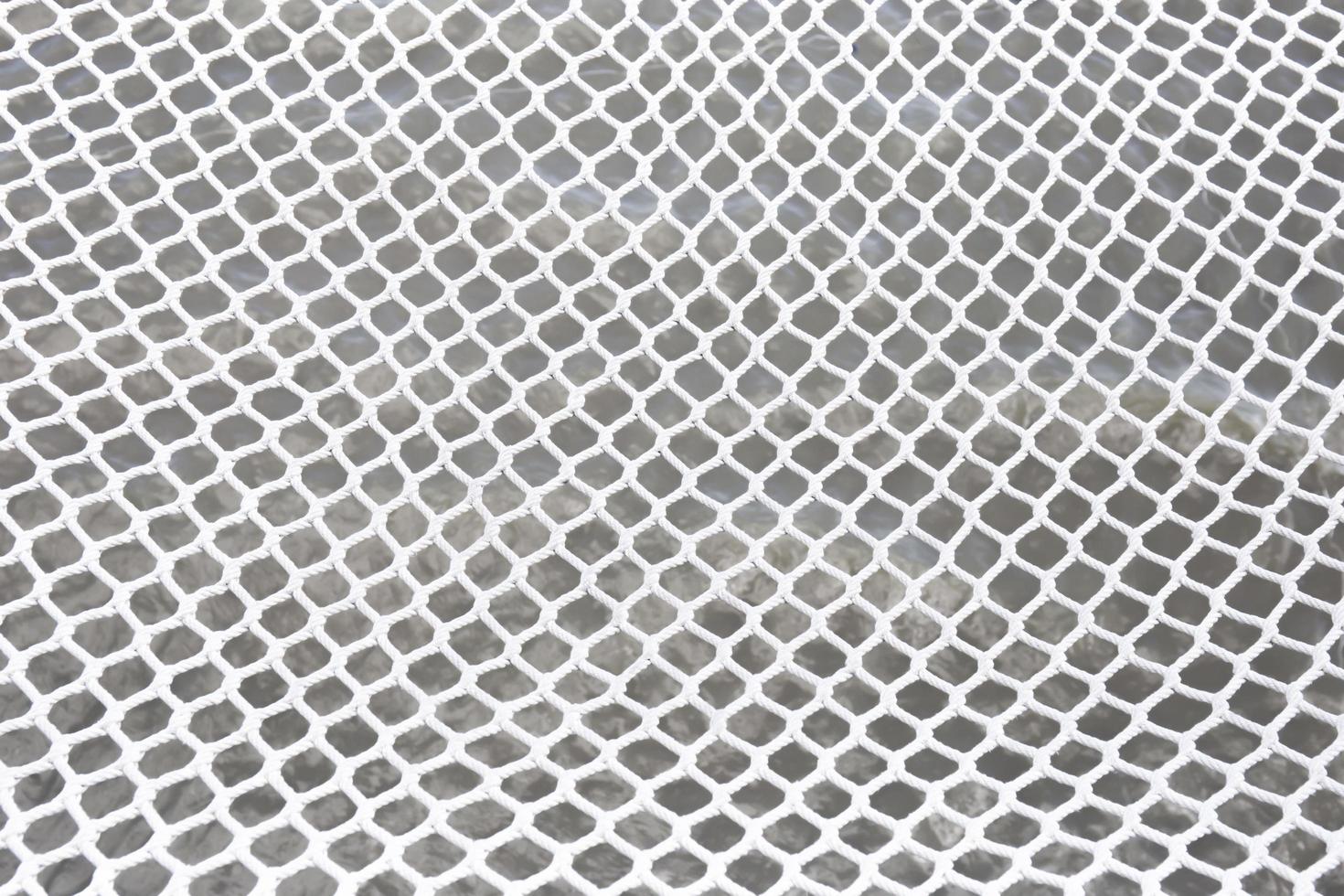 White rope netting on a white background. photo