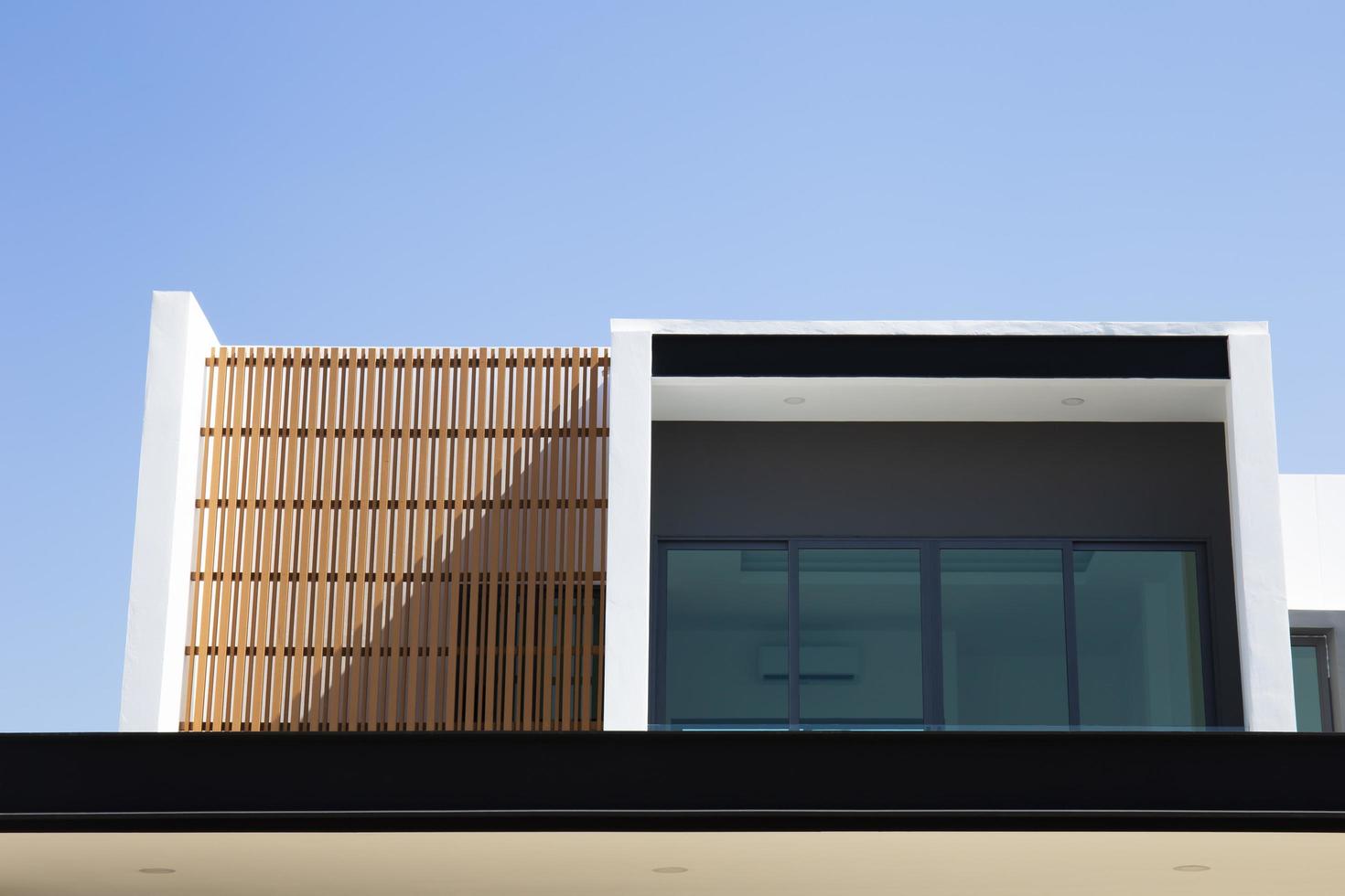 View of a modern style house outside of some buildings. photo
