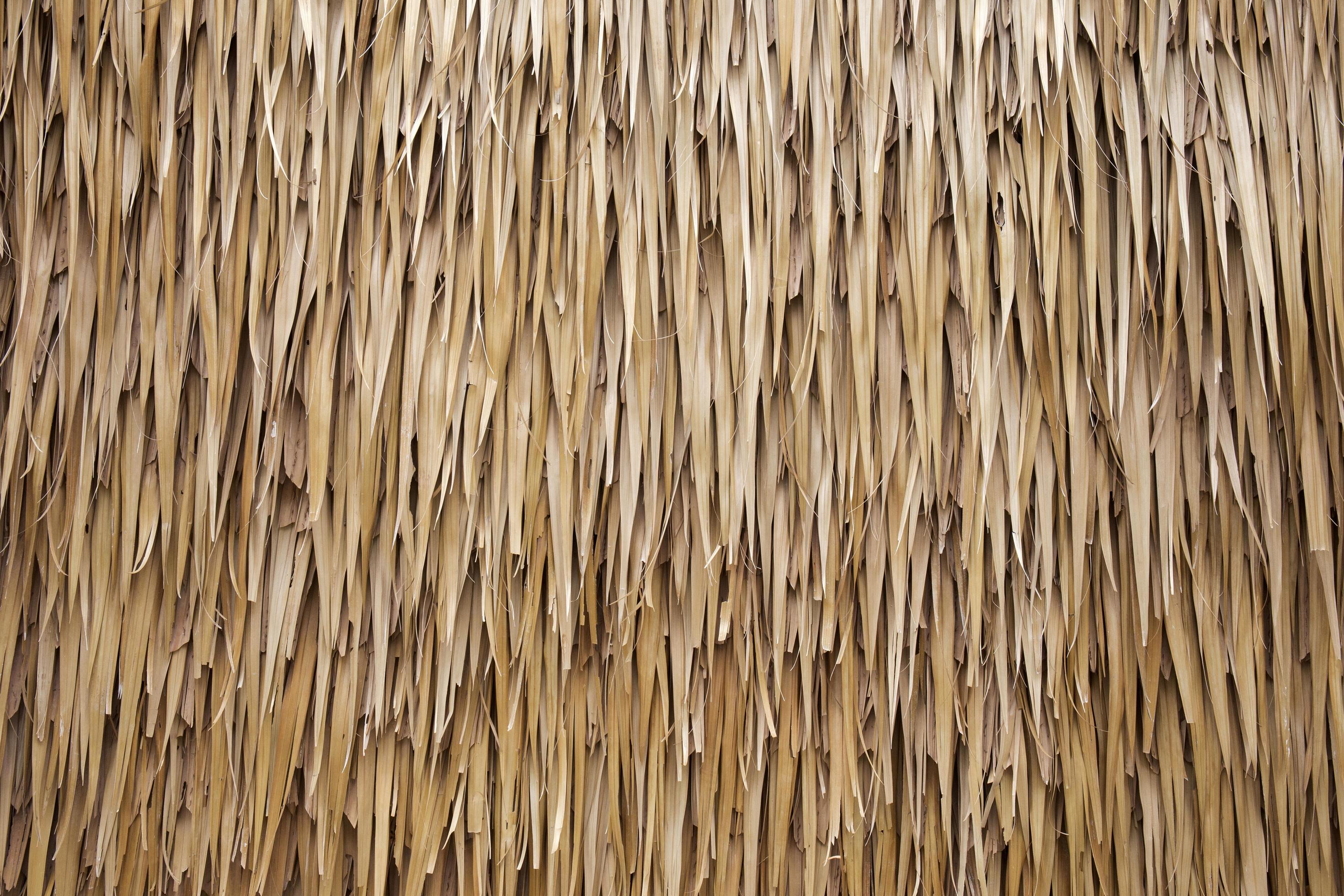 Brown hay roof is stacked on top of each other as a textured background