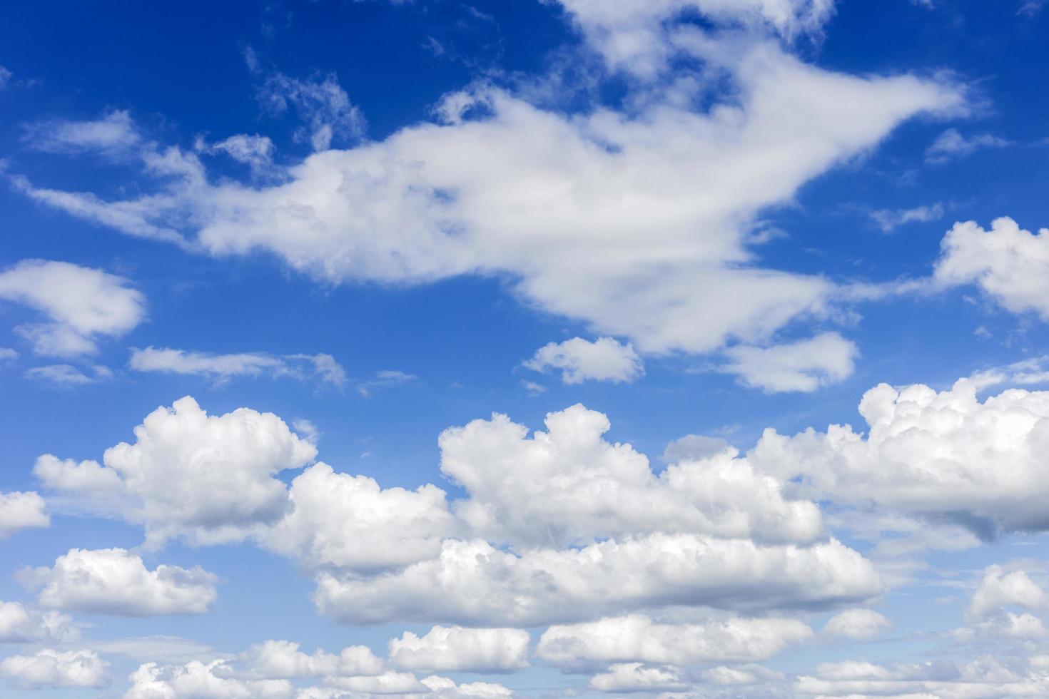 clear blue sky with plain white cloud with space for text background. The vast blue sky and clouds. blue sky background with tiny clouds nature. photo