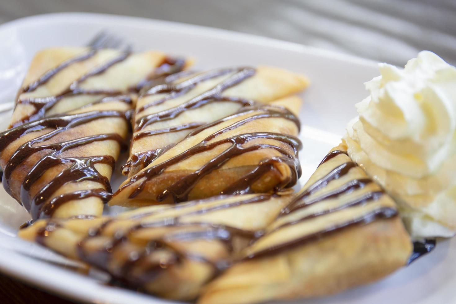 Banana samosas topped with chocolate. photo