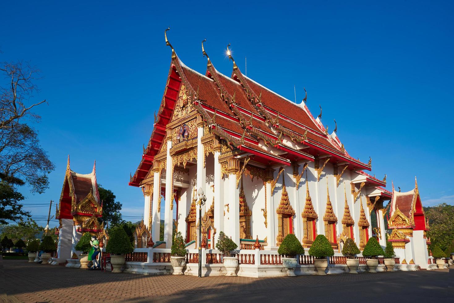 Chalong temple at Phuket province on blue sky background photo