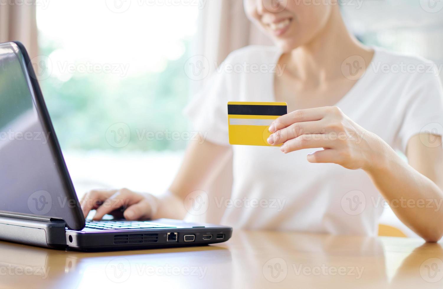 Close up of female hands making online payment photo