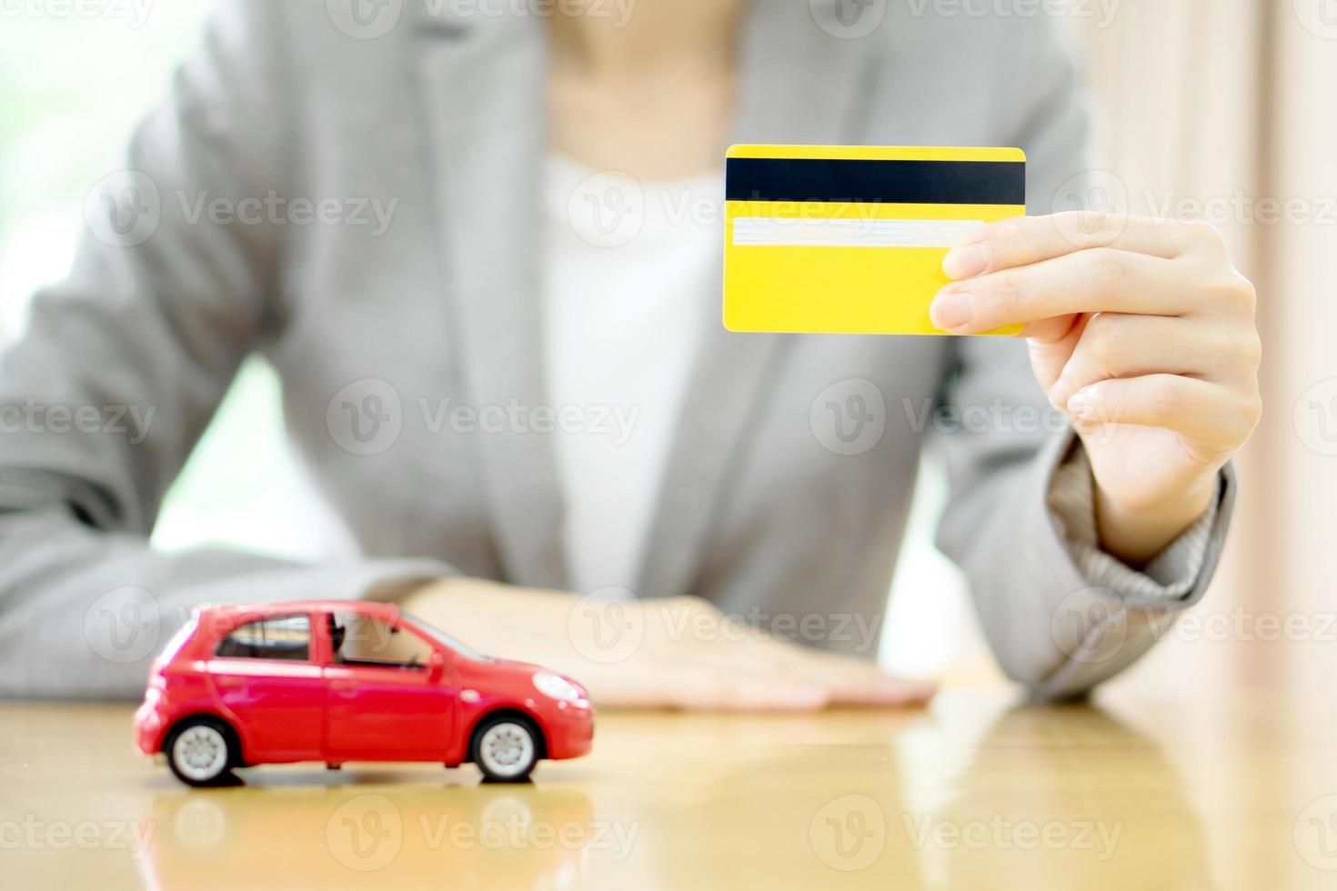 Real estate investment by credit card. Car on table. photo