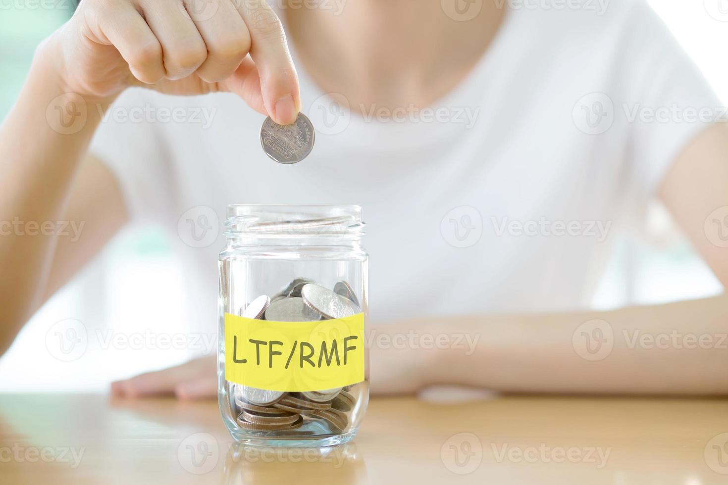 Woman hands with coins in glass jar saving money, close up photo