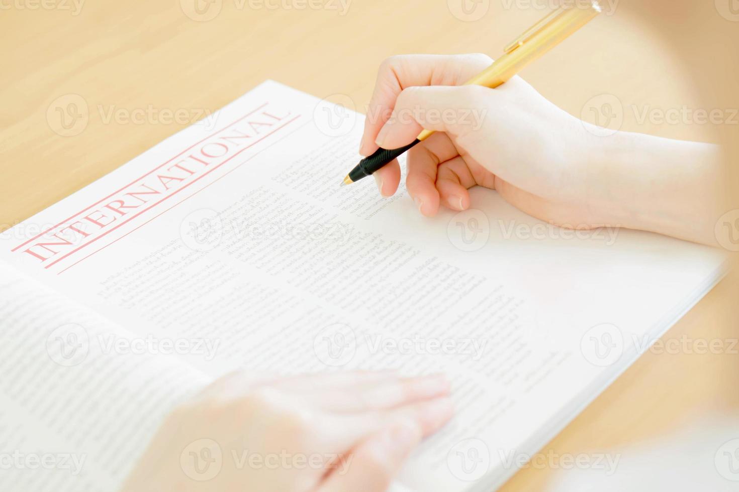 Woman writing on paper photo