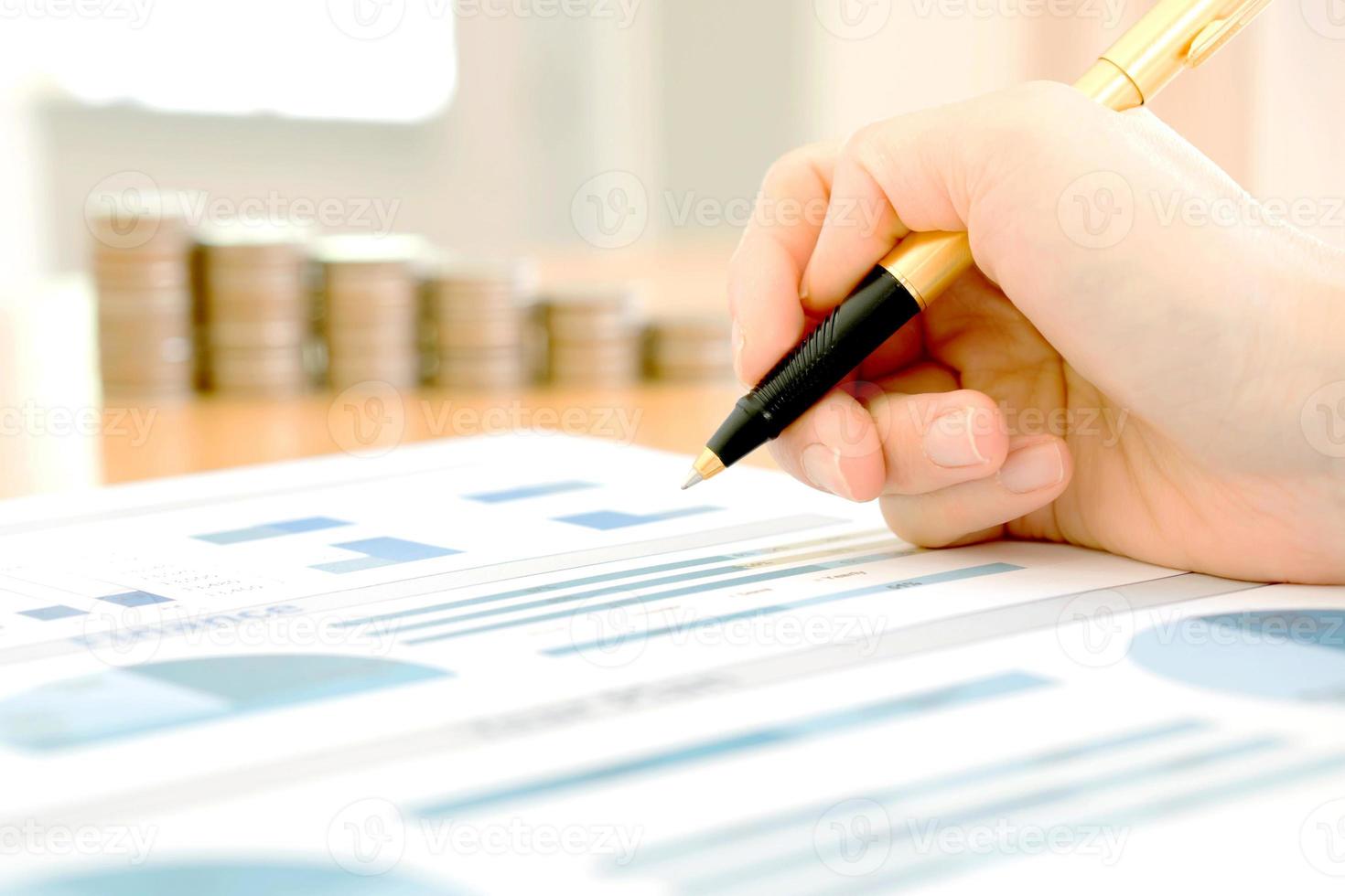 Businesswoman Analyzing Financial Graph With Coins photo