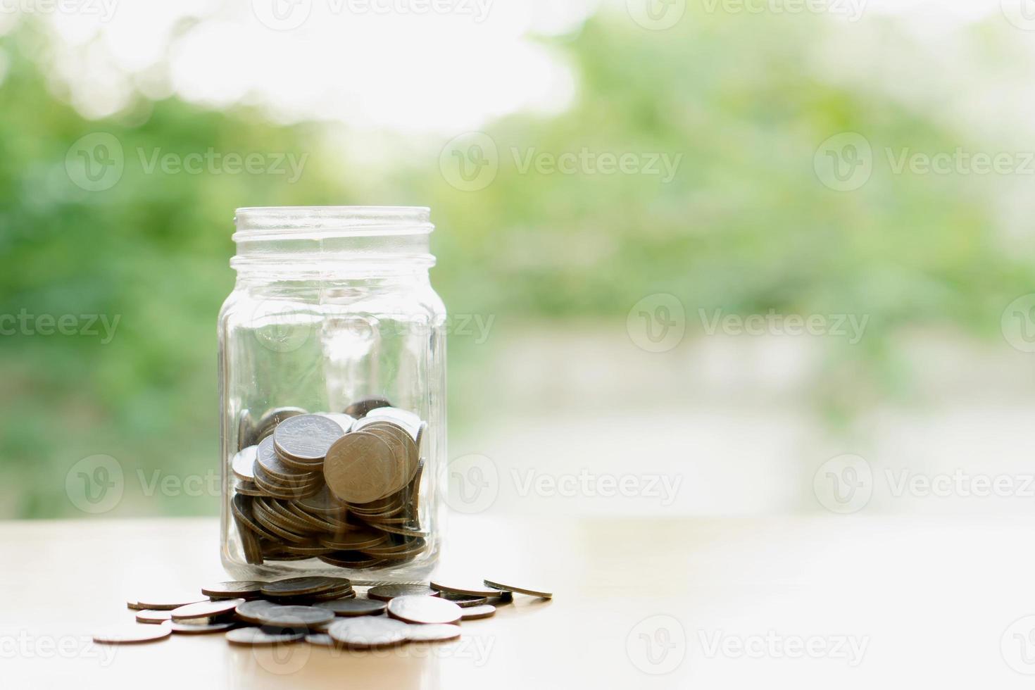 Savings word with money coin in glass jar.financial concept photo