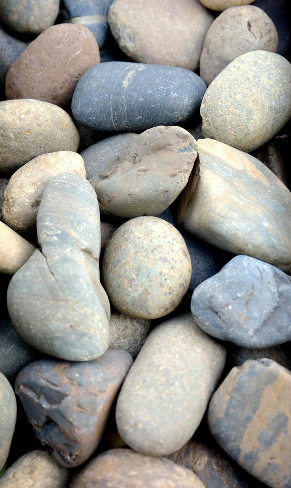Abstract background with dry round pebble stones macro photo