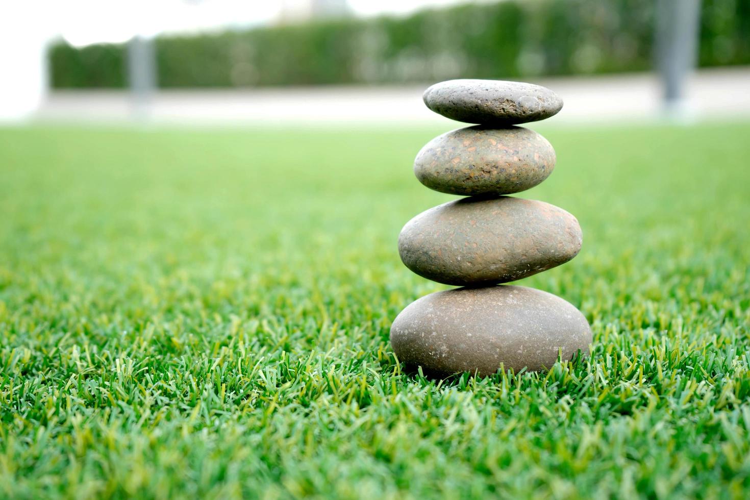 stones stacked up on grass photo