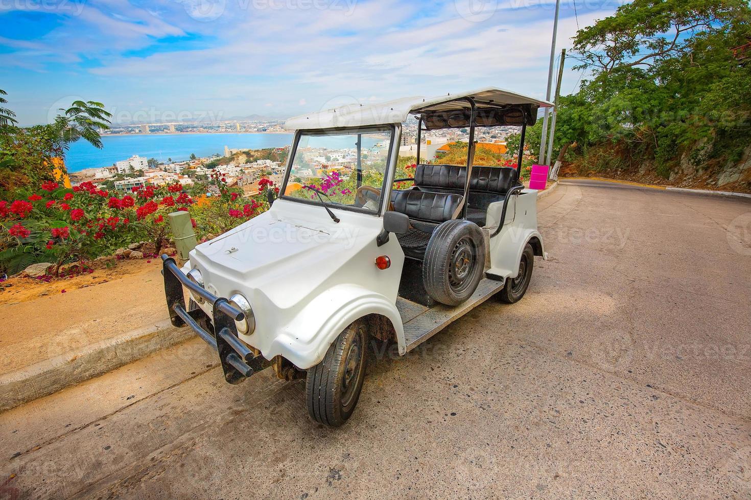 Pulmonia taxi with panoramic view of the Mazatlan Old City in the background, Mexico photo