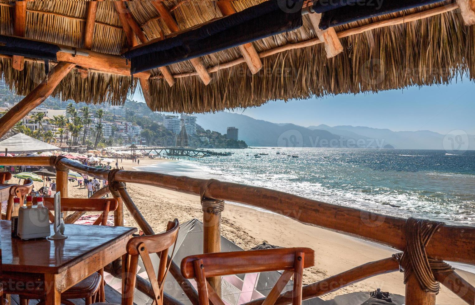 Restaurants and cafes with ocean views on Playa De Los Muertos beach and pier close to famous Puerto Vallarta Malecon, the city largest public beach photo