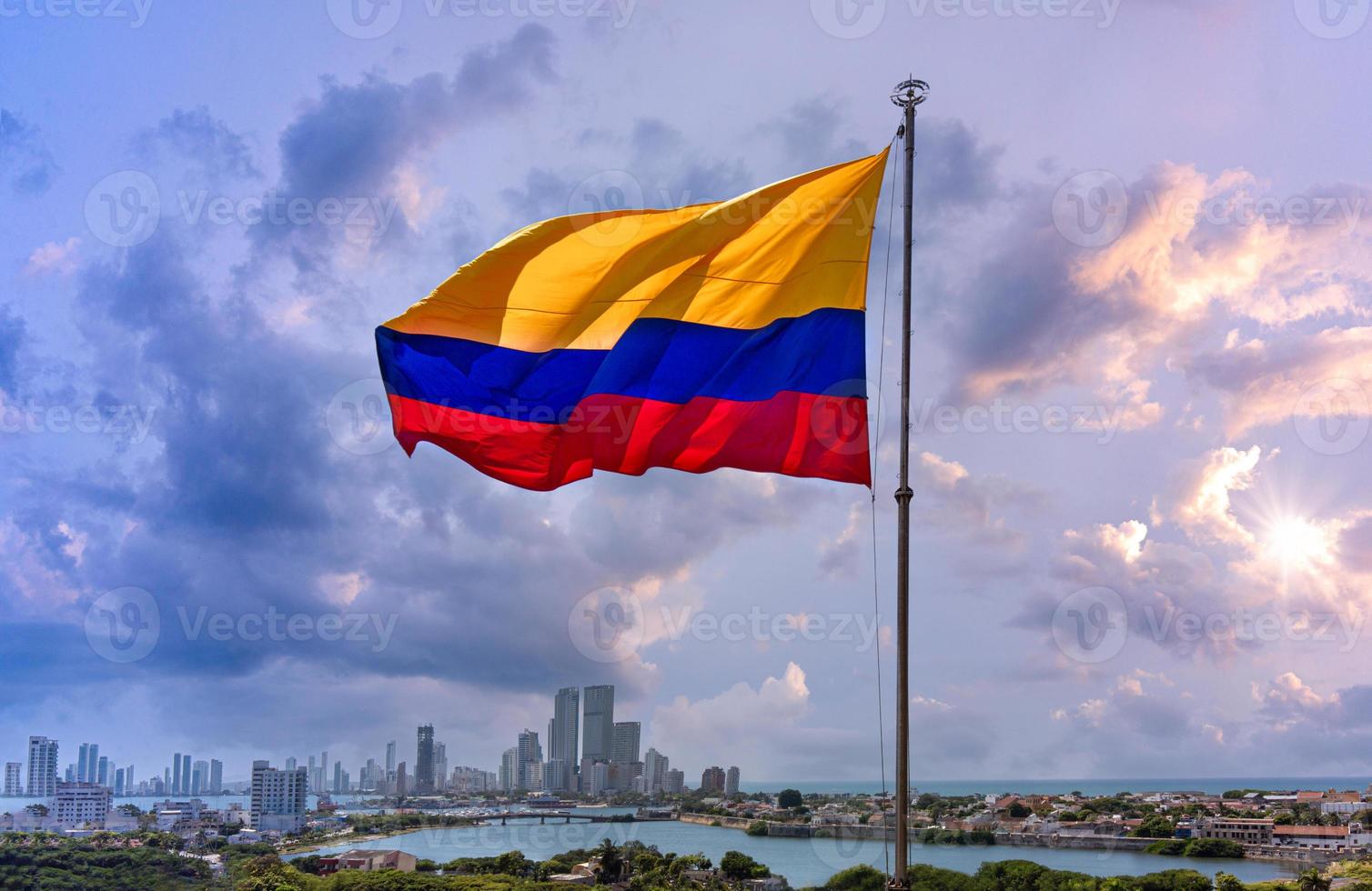 Flag wavering in front of scenic view of Cartagena modern skyline near historic city center and resort hotel zone photo