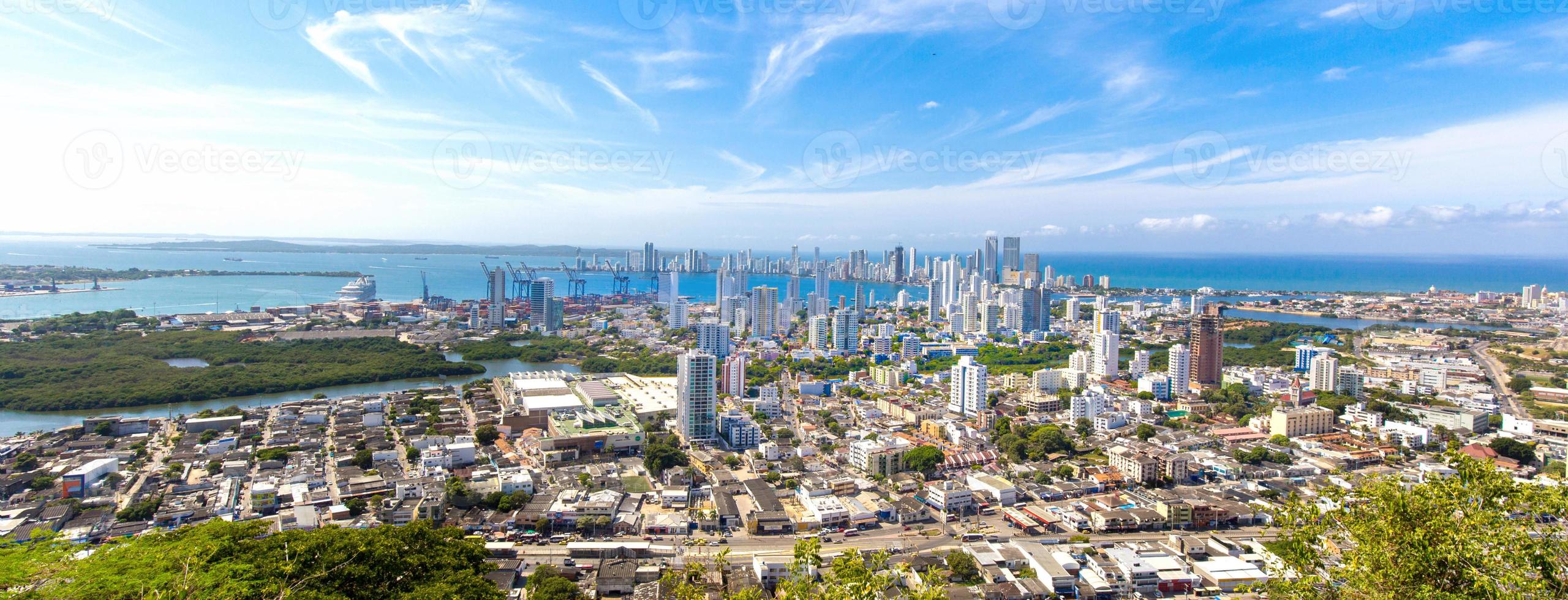 Flag wavering in front of scenic view of Cartagena modern skyline near historic city center and resort hotel zone photo