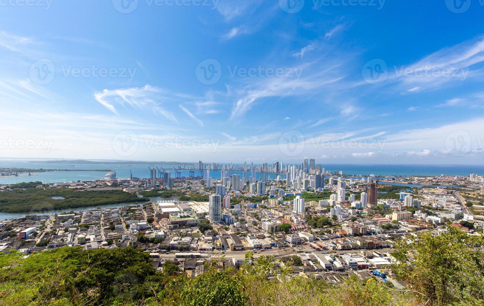 Flag wavering in front of scenic view of Cartagena modern skyline near historic city center and resort hotel zone photo