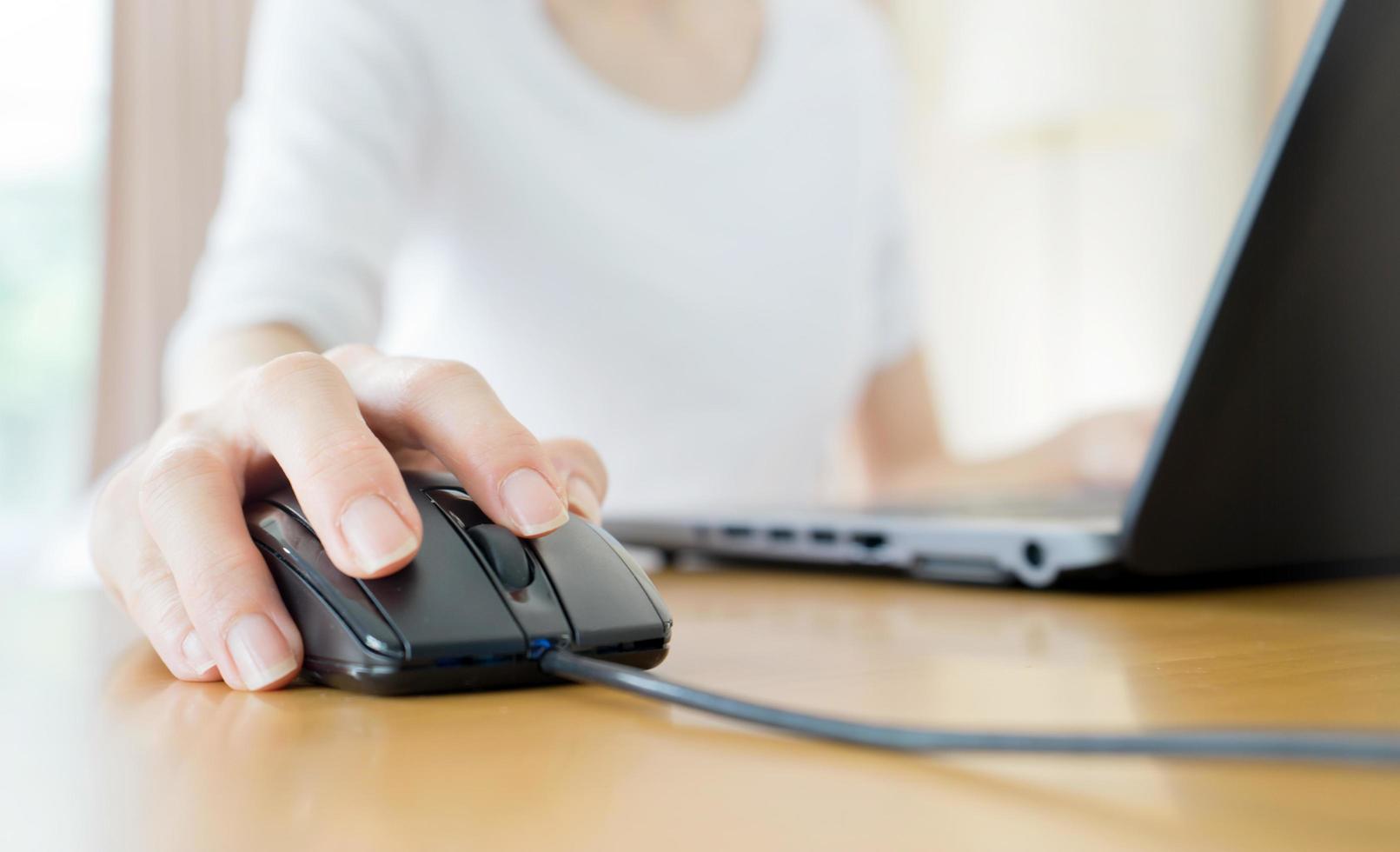 Image of female hands clicking computer mouse photo