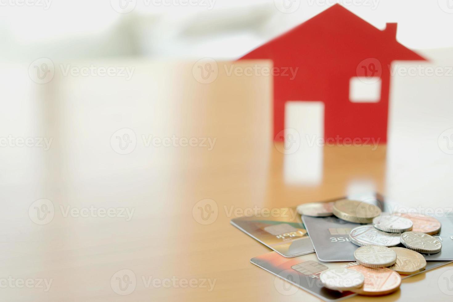 Real estate investment by credit card. House and coins photo