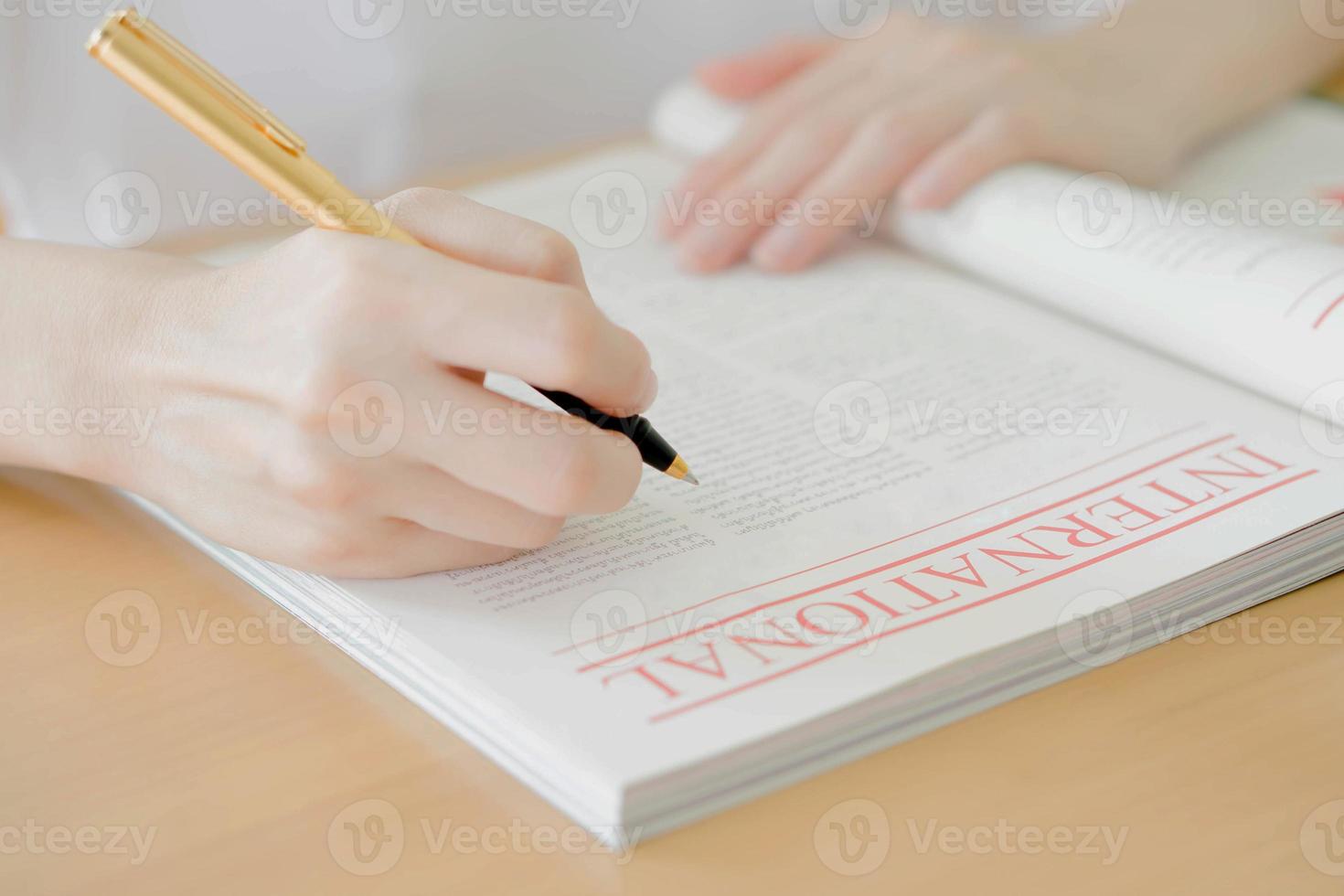 Woman writing on paper photo