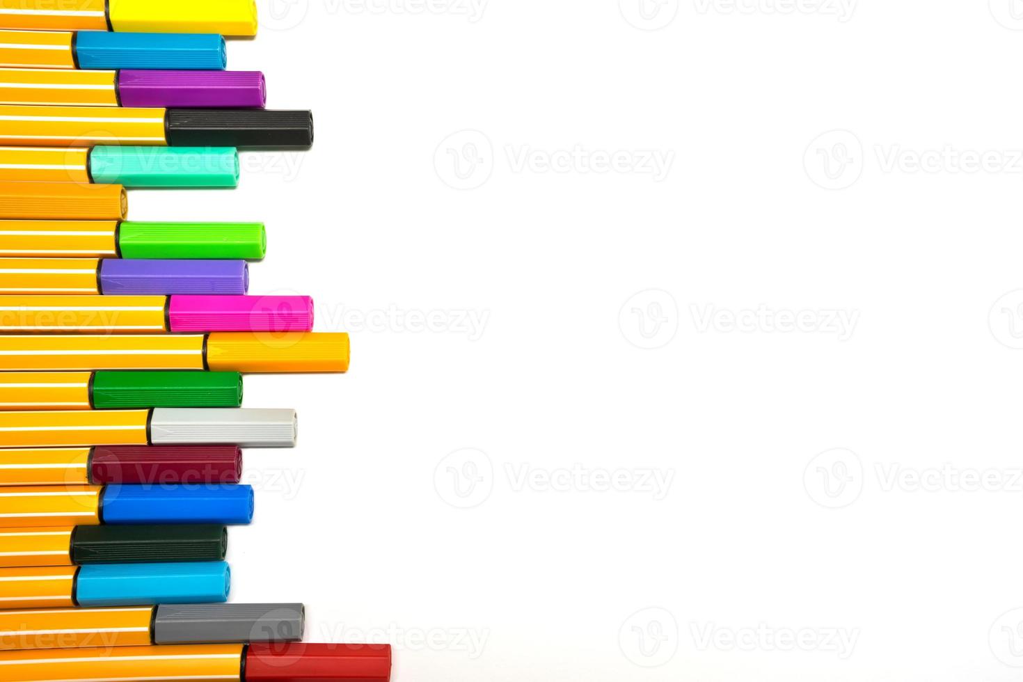 Colorful pens on isolated white background photo