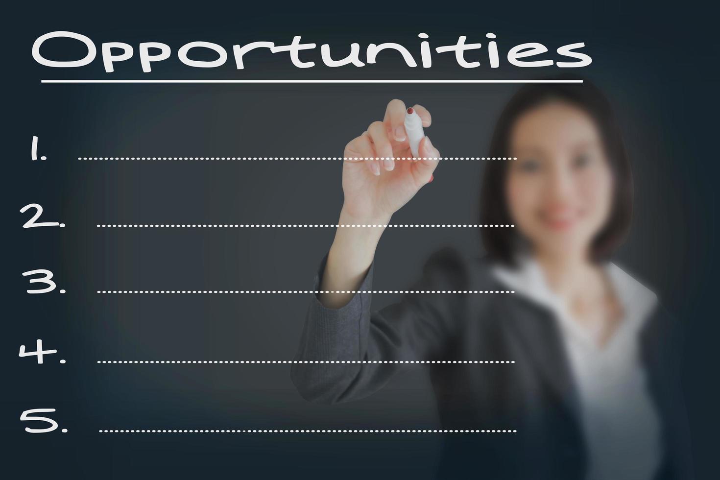 Beautiful businesswoman writing list of business opportunities photo