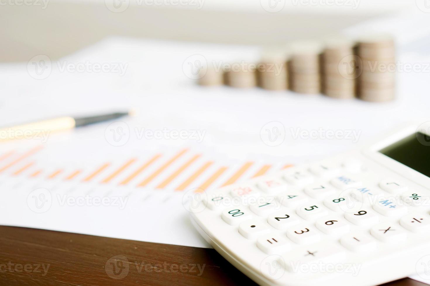 Selective focus calculator, pencil , coin on chart document. photo