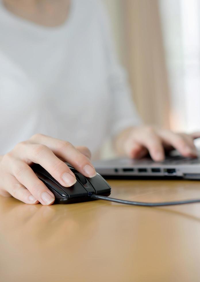 Female hand touching computer mouse closeup photo